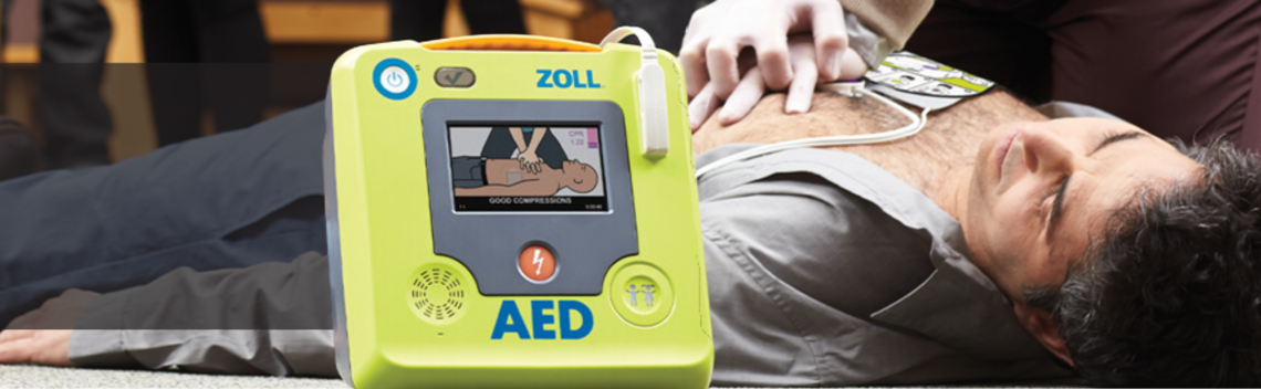 A man is in cardiac arrest, and is having C.P.R. performed on him and an A.E.D. is applied.