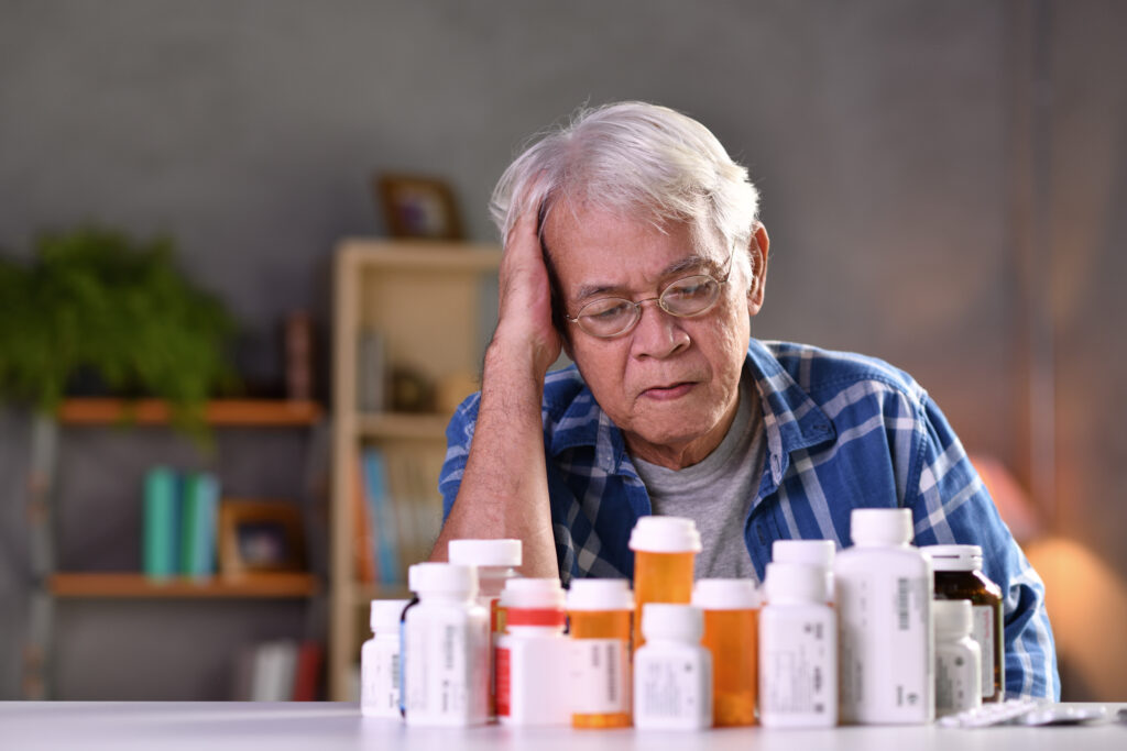 Asian senior man with his medicine bottles